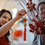 Women hanging up chinese new year decoration