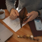 man opening his empty wallet